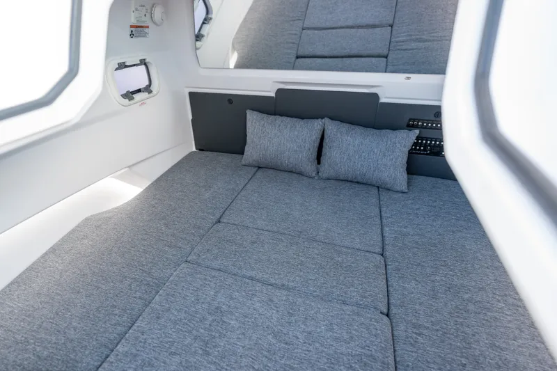 Slide: The Image of Interior cabin of 2026 Axopar 29 CCX with gray cushions and pillows. - 36