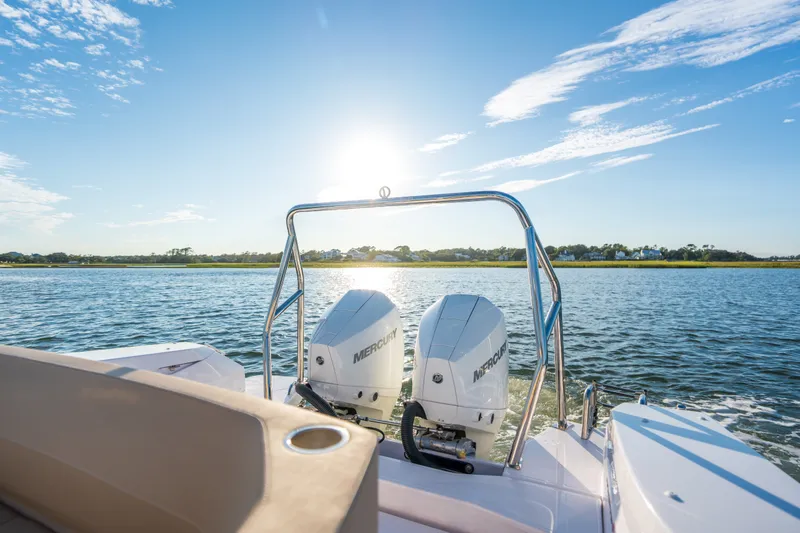 Slide: The Image of 2026 Axopar 29 CCX boat with dual Mercury engines on a sunny day. - 25