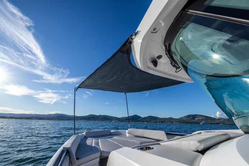 Slide: The Image of 2026 Axopar 29 CCX boat on water, sunny day, scenic mountain view. - 12