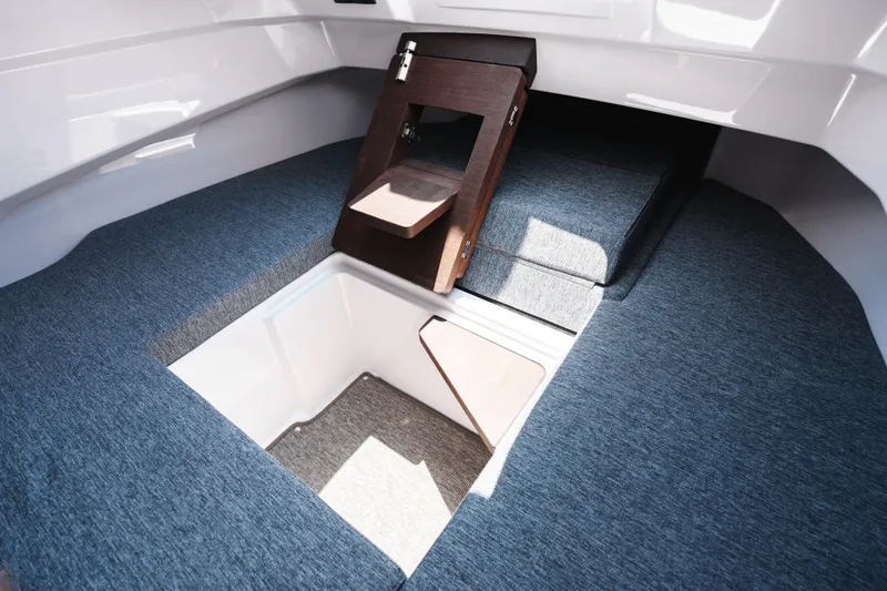 Slide: The Image of Interior view of 2026 Axopar 29 CCX boat cabin with seating and storage. - 20