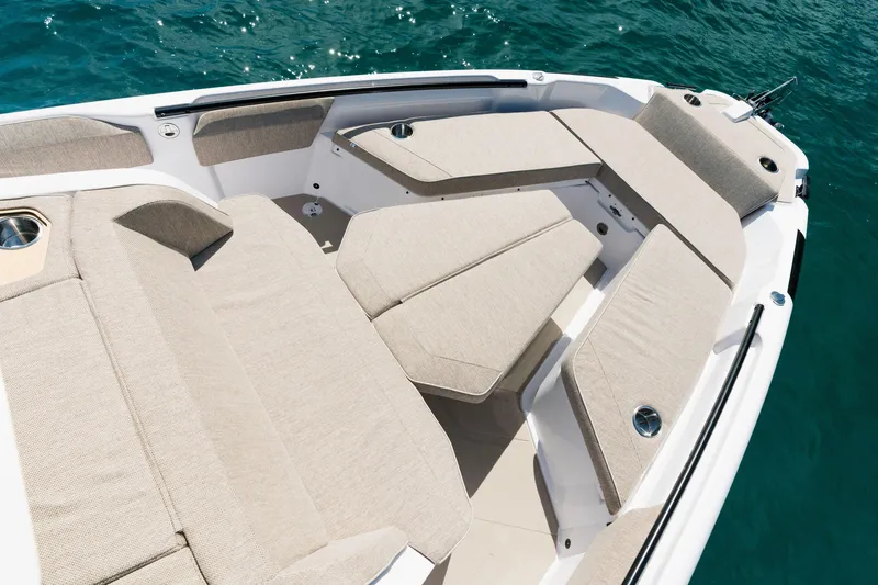 Slide: The Image of Luxurious seating on 2026 Axopar 29 CCX boat, surrounded by clear blue water. - 23