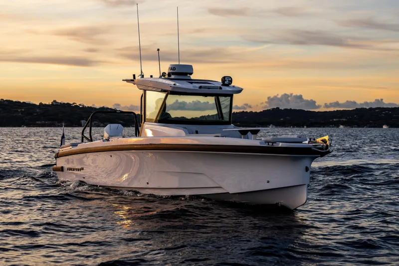 Slide: The Image of 2026 Axopar 29 CCX boat cruising at sunset on calm waters. - 3