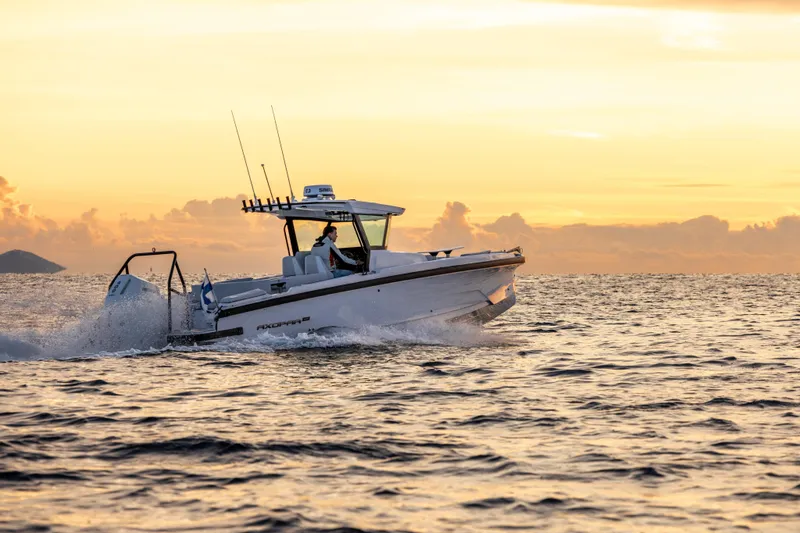 Slide: The Image of 2026 Axopar 29 CCX boat cruising at sunset on open water. - 4