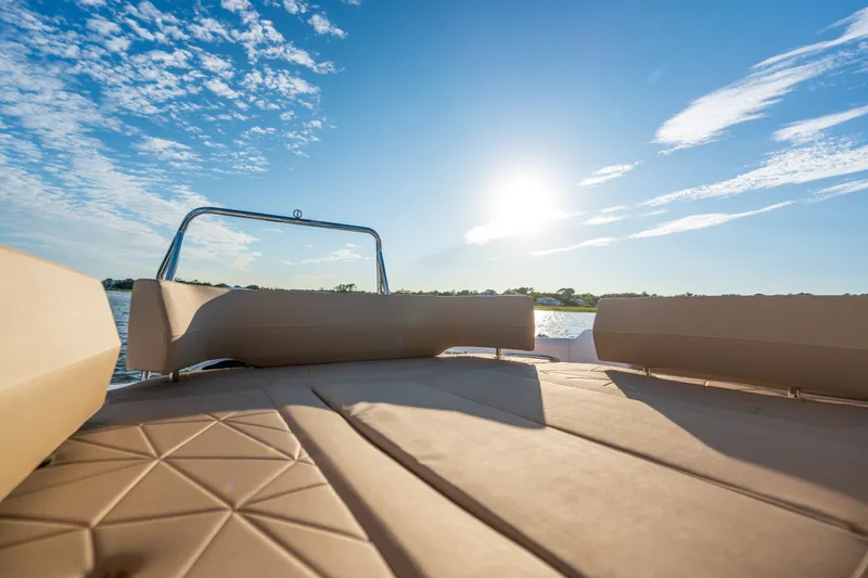 Slide: The Image of 2026 Axopar 29 CCX boat interior with sunlit seating and scenic water view. - 26