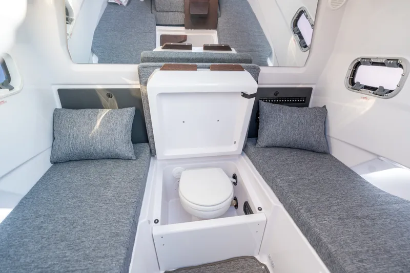 Slide: The Image of Interior of 2026 Axopar 29 CCX boat with cozy seating and hidden toilet. - 37