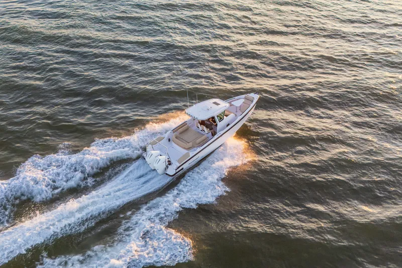 Slide: The Image of Aerial view of 2026 Axopar 29 CCX boat cruising on open water. - 17