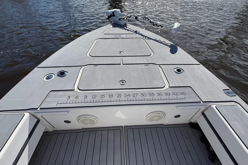 Slide: The Image of 2008 Release Tarpon Bay boat deck with storage compartments and fishing ruler on calm water. - 5