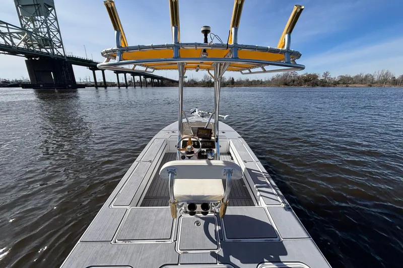 Slide: The Image of 2008 Release Tarpon Bay boat on water near a bridge under clear blue sky. - 7