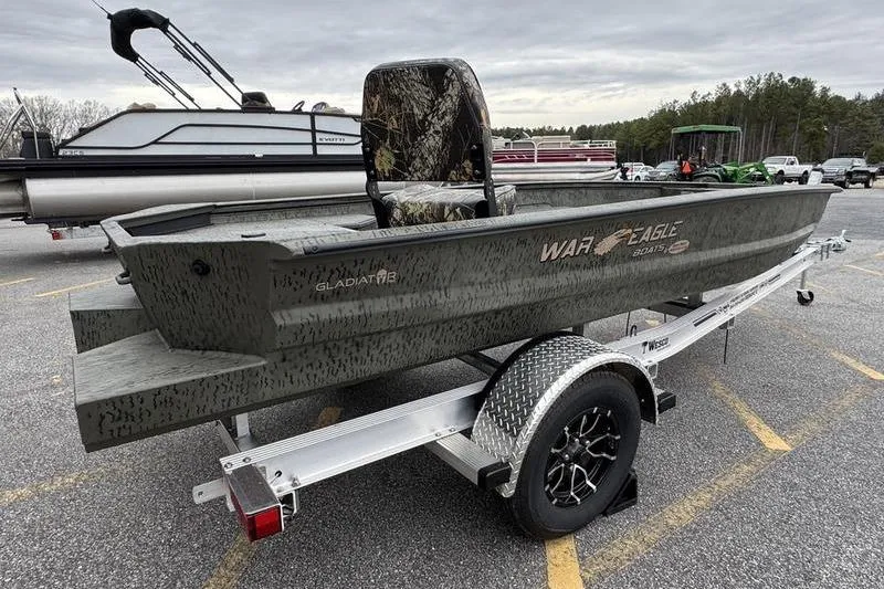 Slide: The Image of 2026 War Eagle 750 Gladiator boat on trailer in parking lot. - 4