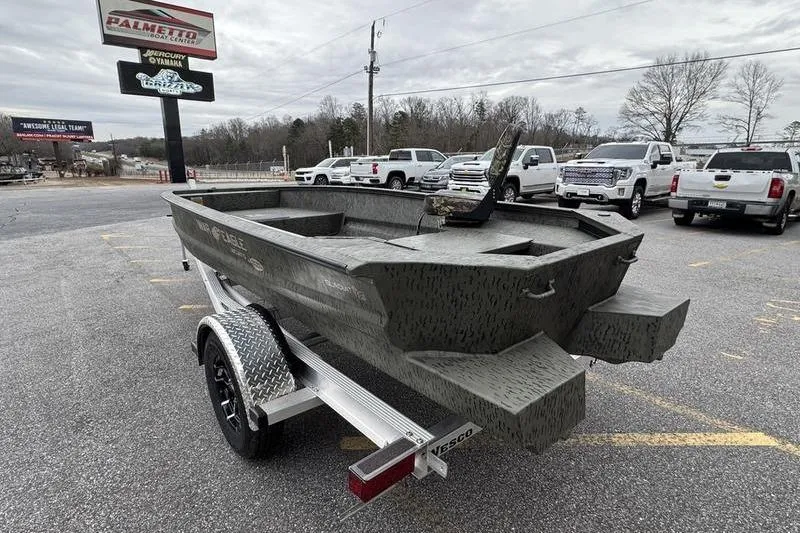 Slide: The Image of 2026 War Eagle 750 Gladiator boat on trailer in parking lot. - 7
