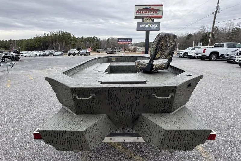 Slide: The Image of 2026 War Eagle 750 Gladiator boat in parking lot, camo design, single seat, dealership sign visible. - 8