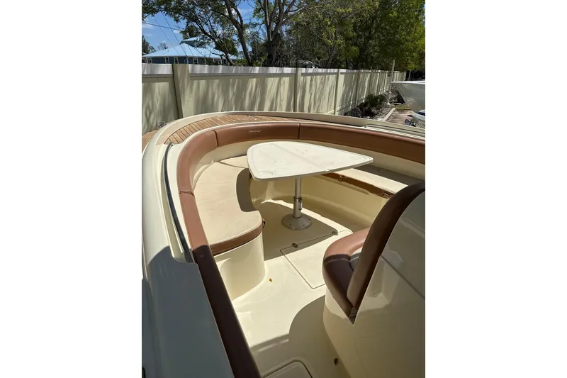 Slide: The Image of 2012 Chris-Craft Catalina 29 boat interior with seating and table, outdoor setting. - 10