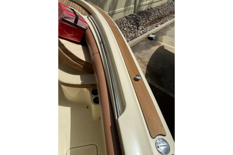 Slide: The Image of 2012 Chris-Craft Catalina 29 boat interior with wood accents and seating. - 12