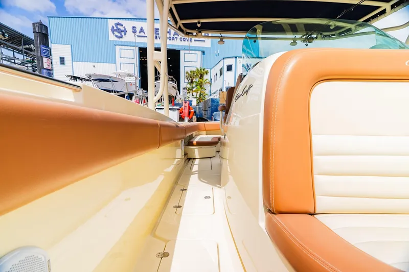 Slide: The Image of 2012 Chris-Craft Catalina 29 Sun Tender interior with tan leather seating at marina. - 17