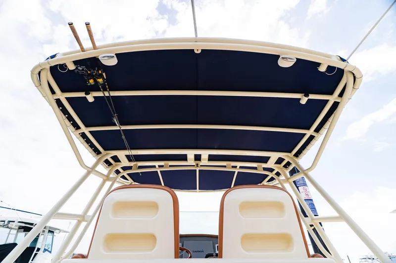 Slide: The Image of 2012 Chris-Craft Catalina 29 Sun Tender boat with blue canopy and fishing rods. - 18