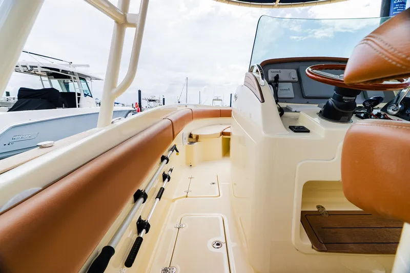 Slide: The Image of 2012 Chris-Craft Catalina 29 Sun Tender interior with tan seating and steering console. - 20
