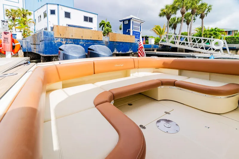 Slide: The Image of 2012 Chris-Craft Catalina 29 Sun Tender with tan seating at a marina dock. - 22