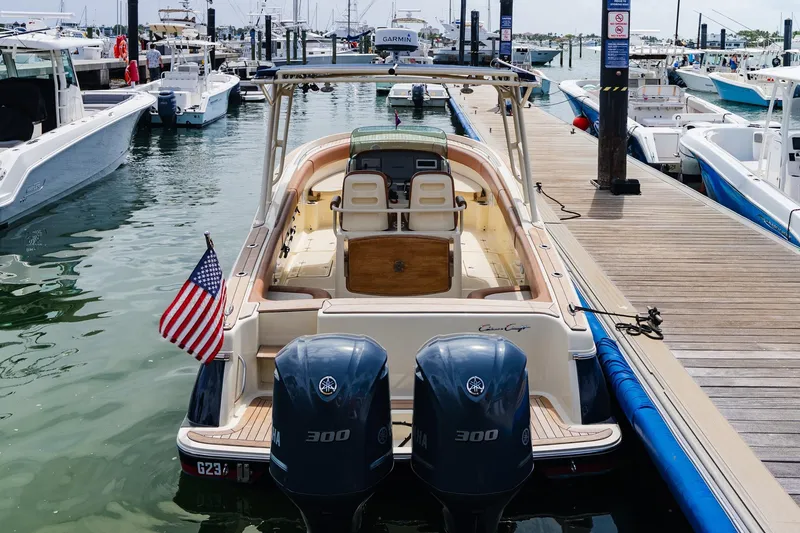 Slide: The Image of 2012 Chris-Craft Catalina 29 Sun Tender docked at marina with American flag. - 23