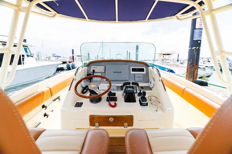 Slide: The Image of 2012 Chris-Craft Catalina 29 Sun Tender helm with steering wheel and navigation equipment. - 24