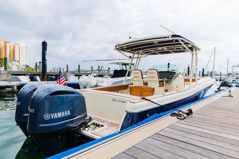 Slide: The Image of 2012 Chris-Craft Catalina 29 Sun Tender docked with Yamaha engines, marina background. - 28