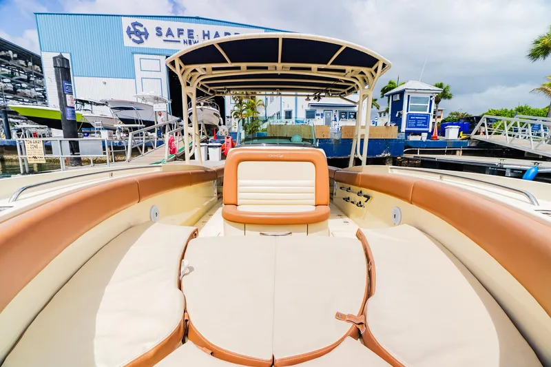 Slide: The Image of 2012 Chris-Craft Catalina 29 Sun Tender docked at marina, featuring spacious seating. - 29