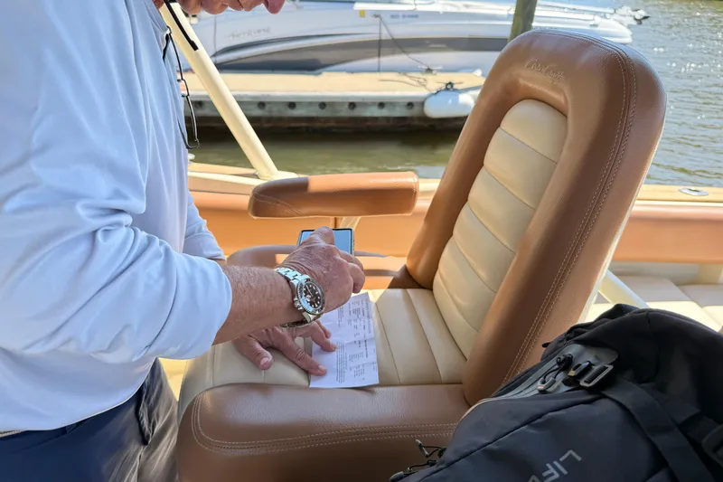 Slide: The Image of Person signing document on Chris-Craft Catalina 29 boat, 2012 model, with leather seat. - 3