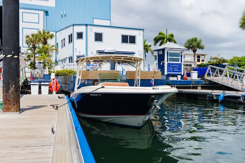 Slide: The Image of 2012 Chris-Craft Catalina 29 Sun Tender docked at a marina with blue buildings. - 30