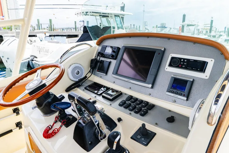 Slide: The Image of 2012 Chris-Craft Catalina 29 Sun Tender helm with navigation controls and steering wheel. - 31