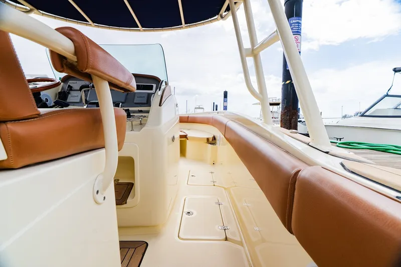 Slide: The Image of 2012 Chris-Craft Catalina 29 Sun Tender interior with tan leather seating and helm controls. - 32