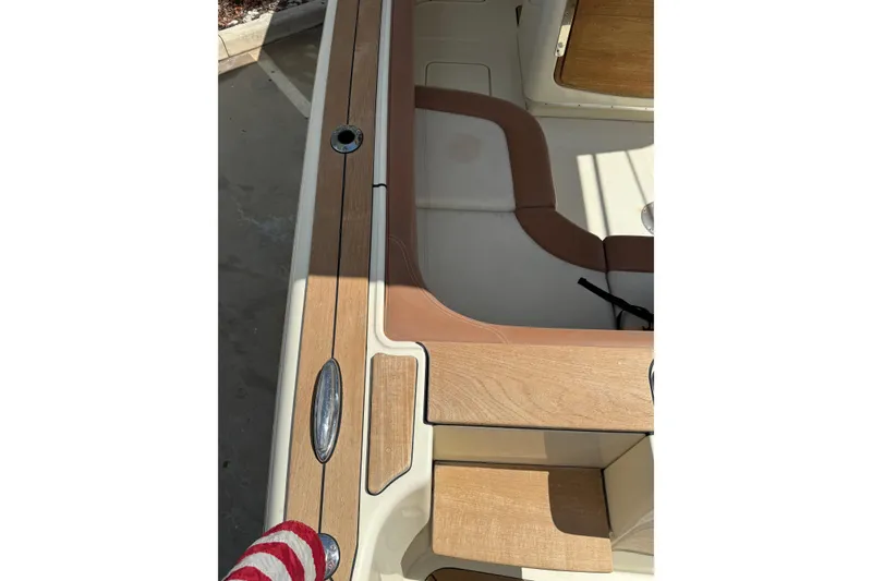 Slide: The Image of 2012 Chris-Craft Catalina 29 boat interior with wood and leather details. - 33