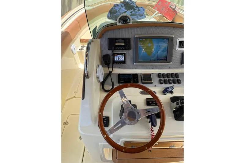 Slide: The Image of 2012 Chris-Craft Catalina 29 dashboard with navigation screen and wooden steering wheel. - 9