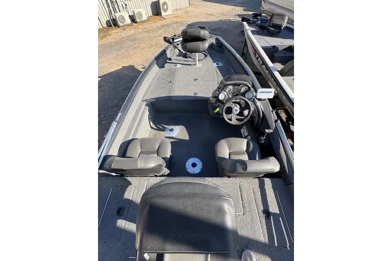 Slide: The Image of 2019 Tracker Pro Team 175 TF boat interior with seating and steering console. - 4