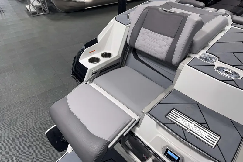 Slide: The Image of 2022 Malibu Wakesetter 25 LSV boat interior with gray seating and cup holders. - 26