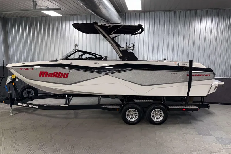 Slide: The Image of 2022 Malibu Wakesetter 25 LSV boat on trailer in indoor storage. - 29