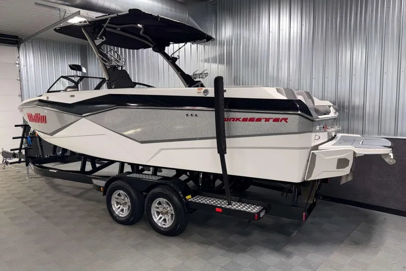 Slide: The Image of 2022 Malibu Wakesetter 25 LSV boat in a showroom, side view. - 30
