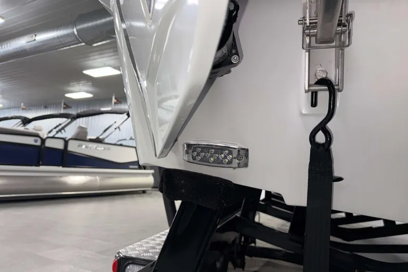 Slide: The Image of 2022 Malibu Wakesetter 25 LSV boat detail in showroom, featuring sleek design elements. - 34