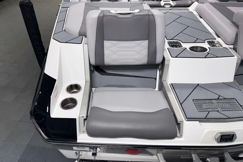 Slide: The Image of 2022 Malibu Wakesetter 25 LSV boat interior with gray seating and cup holders. - 4