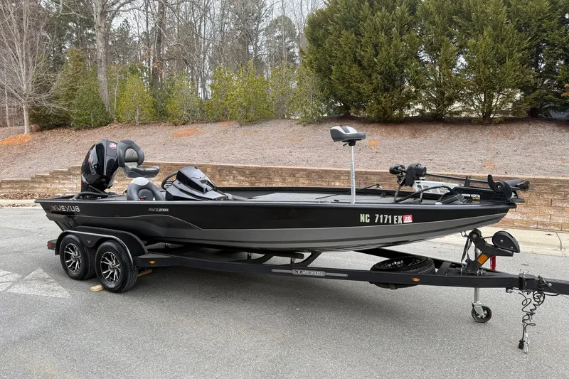 The Image of 2021 Vexus AVX2080 boat on trailer, parked outdoors with trees in background. - 0