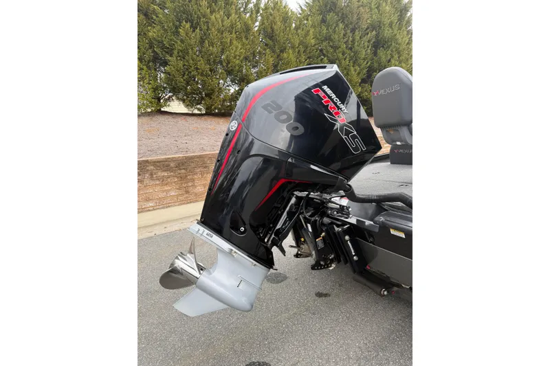 Slide: The Image of 2021 Vexus AVX2080 boat with Mercury Pro XS outboard motor, parked outdoors. - 12