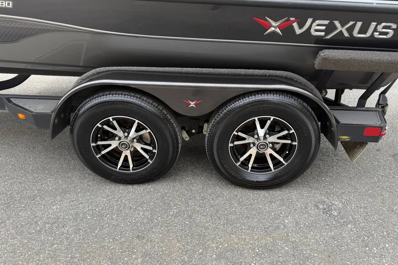 Slide: The Image of 2021 Vexus AVX2080 boat trailer with dual black alloy wheels on asphalt. - 13