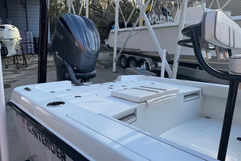 Slide: The Image of 2023 Contender 25 Bay boat with Yamaha outboard motor in a marina setting. - 11