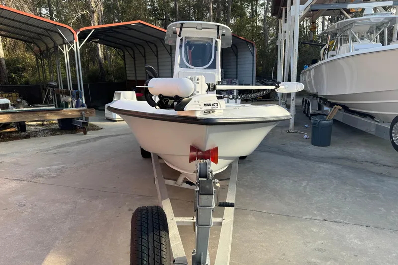 Slide: The Image of 2023 Contender 25 Bay boat on trailer in storage facility. - 13