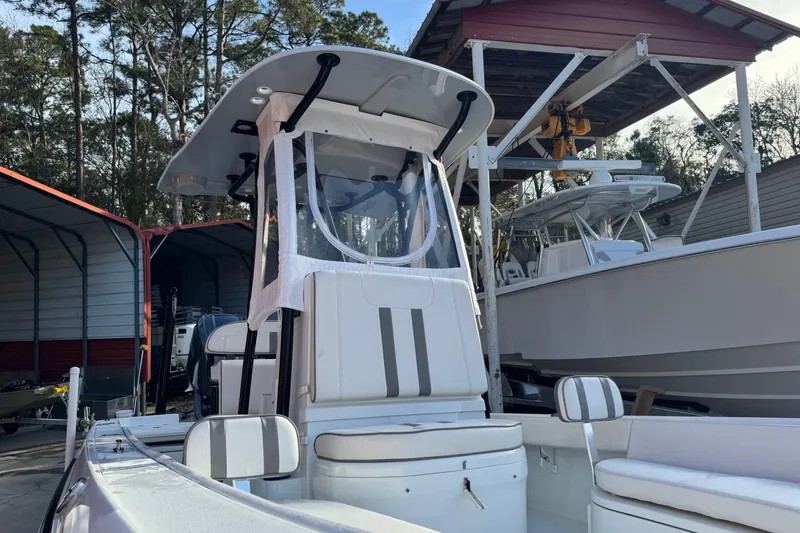 Slide: The Image of 2023 Contender 25 Bay boat in storage, featuring sleek design and modern amenities. - 16