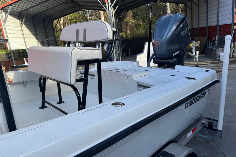 Slide: The Image of 2023 Contender 25 Bay boat with Yamaha outboard motor in covered storage. - 18