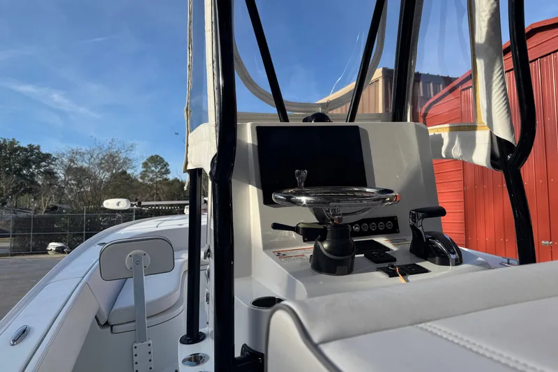 Slide: The Image of 2023 Contender 25 Bay boat console with steering wheel and controls. - 19