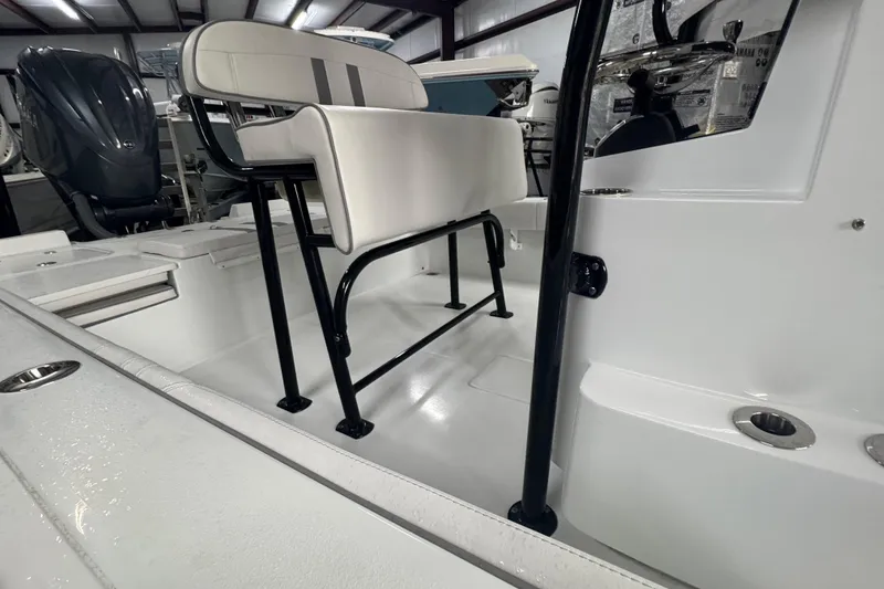 Slide: The Image of 2023 Contender 25 Bay boat interior with seating and engine view. - 28