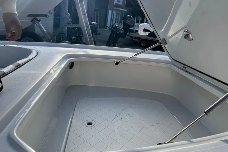 Slide: The Image of 2023 Contender 25 Bay boat storage compartment with open lid, showcasing interior design. - 34