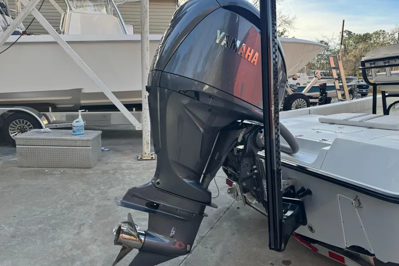 Slide: The Image of 2023 Contender 25 Bay boat with Yamaha outboard motor in a marina setting. - 7