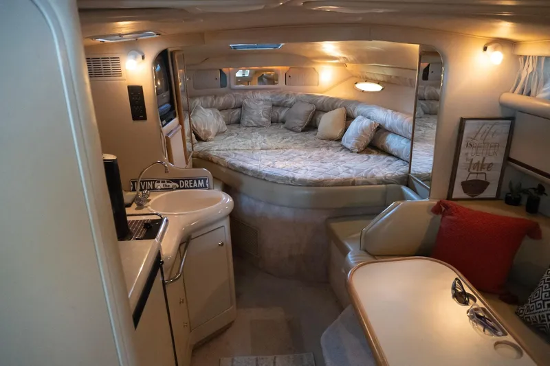 Slide: The Image of 1998 Sea Ray Sundancer 330 cabin interior with cozy seating and sleeping area. - 13
