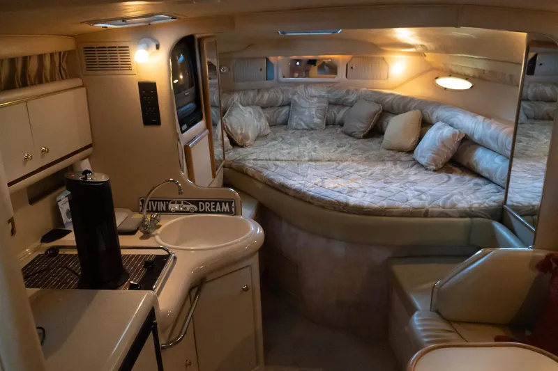 Slide: The Image of Interior of 1998 Sea Ray Sundancer 330 yacht with cozy sleeping area and kitchenette. - 14
